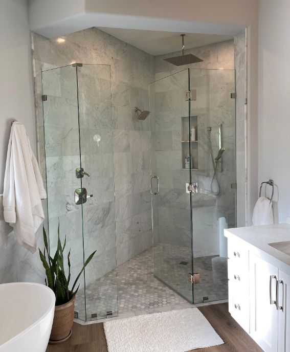 Bathroom Remodeling Company Queens NY: Bathroom was installed with marble tiles and glass enclosure for the shower area. All fixtures and bathroom cabinets were also installed by the Bathroom Remodeling company.